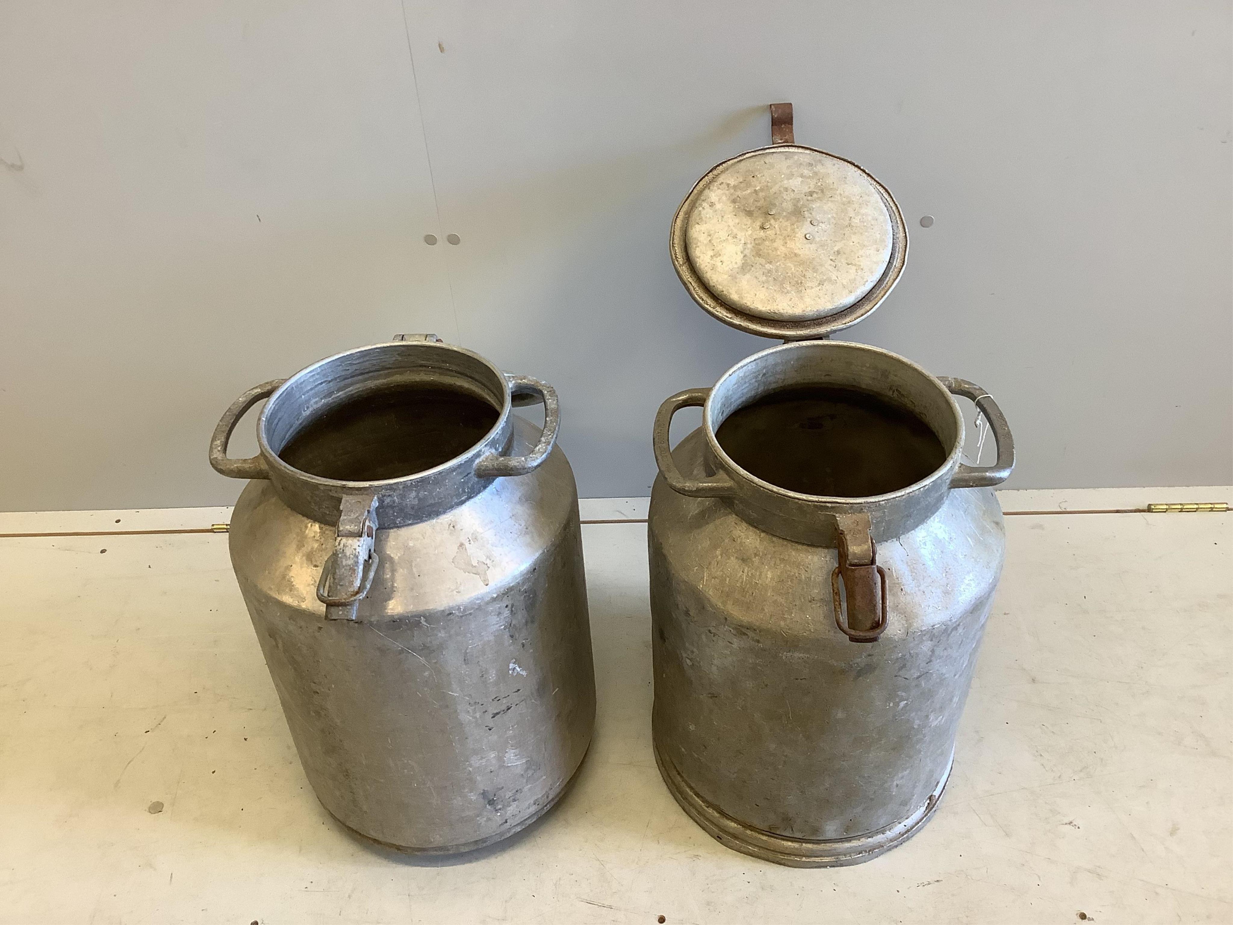 A pair of vintage galvanised milk churns, height 52cm